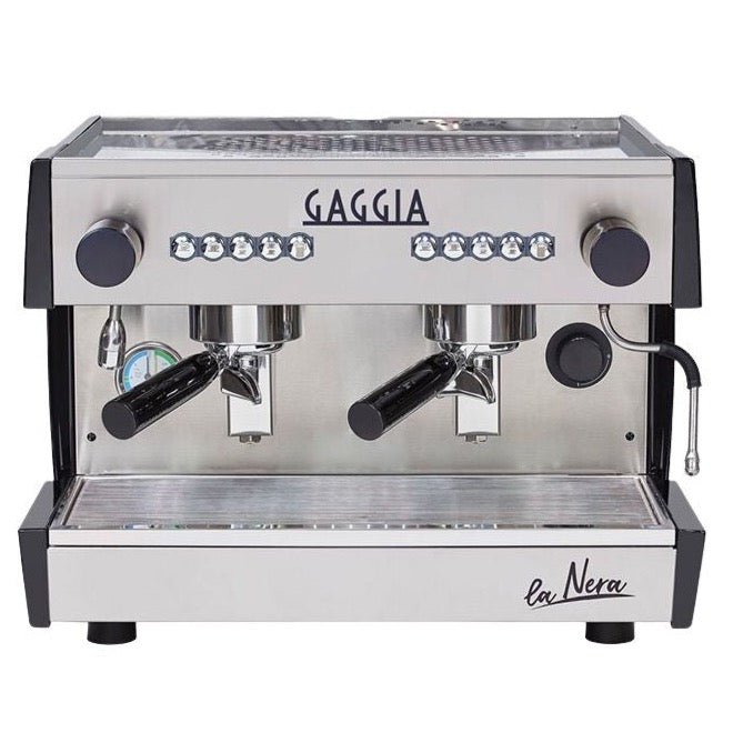 "Image of a sleek Gaggia La Nera Compact 2 Group Espresso Machine, featuring a polished stainless steel exterior with two group heads for brewing espresso. The machine is elegantly designed, with a prominent Gaggia logo, control buttons, and steam wands, showcasing a professional and compact espresso-making apparatus."